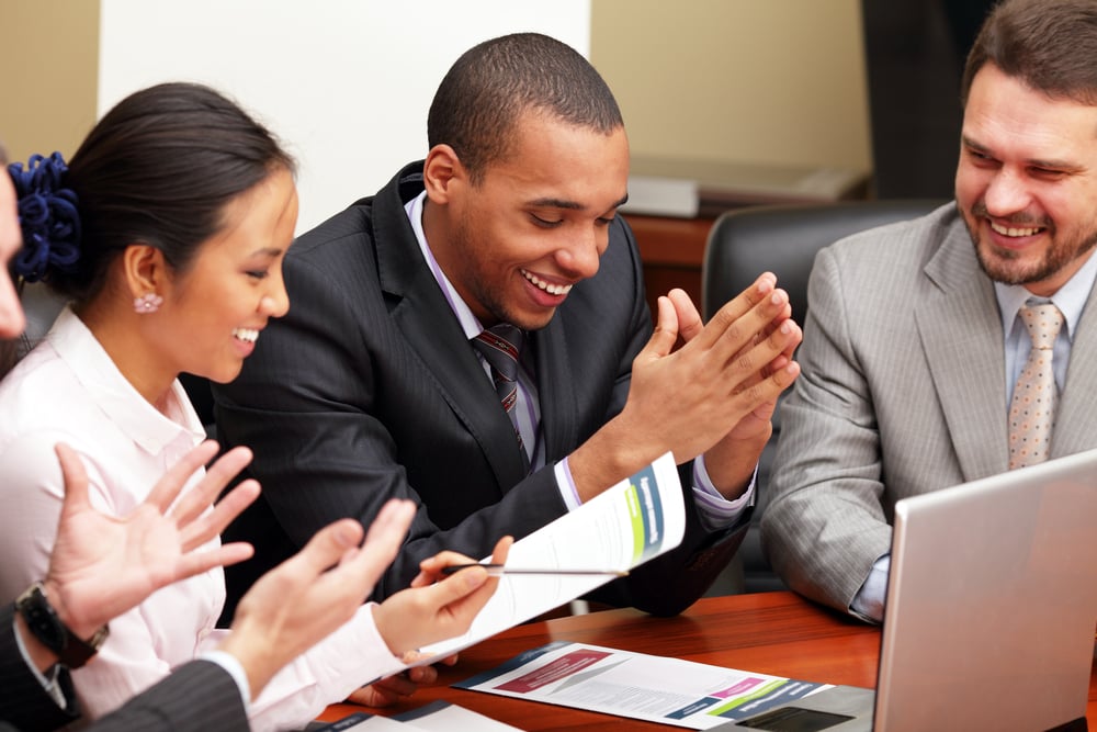 Multi ethnic business team at a meeting. Interacting. Focus on african-american man